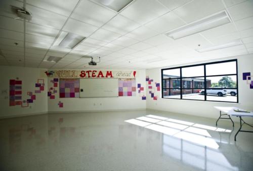 A large open classroom with no furniture