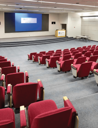 Red theater seating in the school auditorium