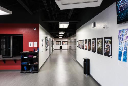 hallway with lockers and student art along the wall