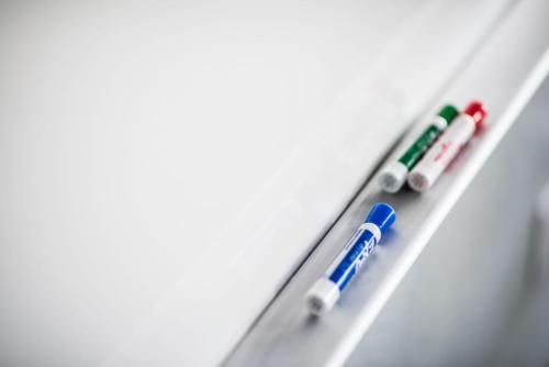 closeup view of dry erase markers and white board