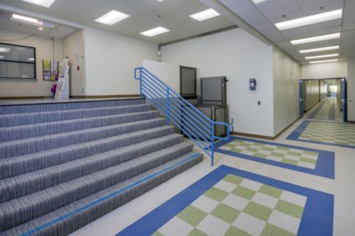hallway with large staircase