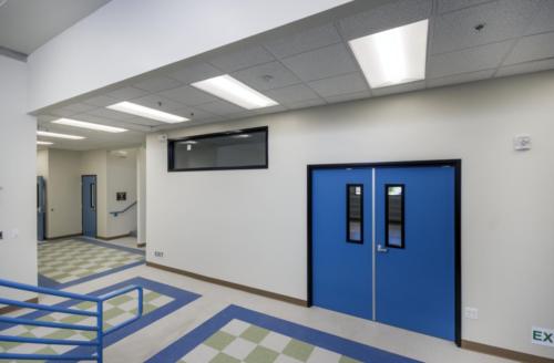 stairs leading to a blue double door