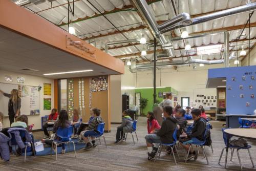kids watching a teacher at the chalkboard
