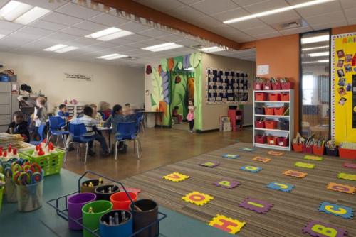 students sitting at group desks inside classroom
