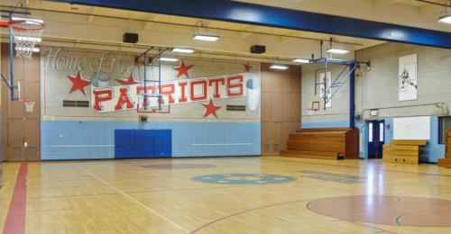school gym with multiple basketball courts