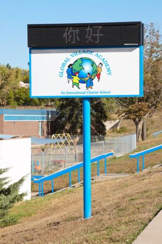 roadside sign for Global Village Academy