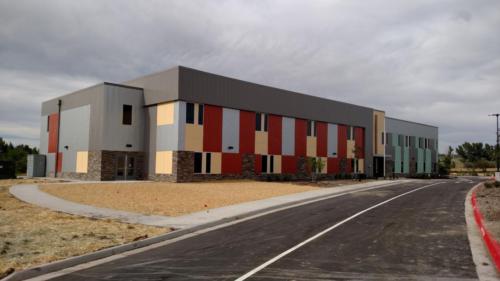 Wide angle shot of school exterior and parking lot