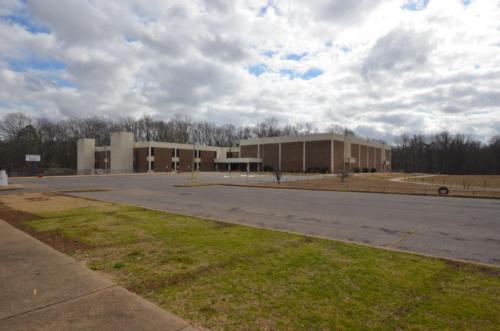 Wide view of the school from across the parking lot