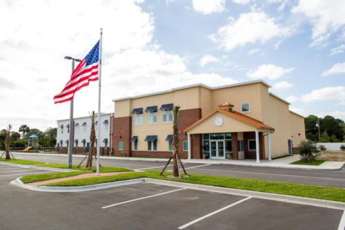 School exterior and a U.S. flag