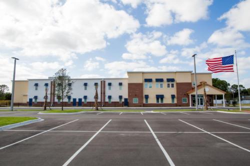 School parking lot with school building in the background