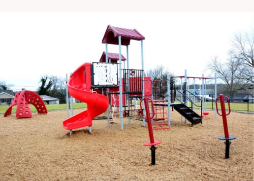 School exterior with red playground equipment