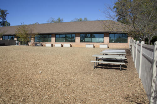 Folding tables in a fenced-in outdoor area