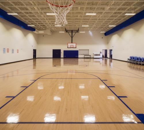 View of the school gym from under a basketball hoop