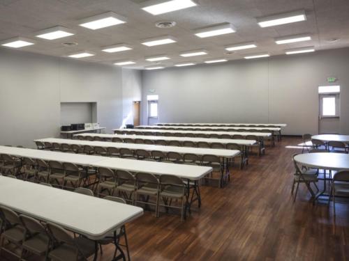 A cafeteria with large folding tables and chairs