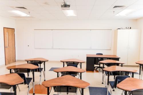 A small classroom filled with triangular desks