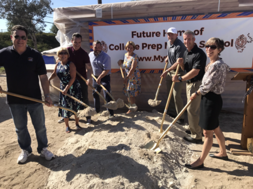team members holding shovels for charter school groundbreaking