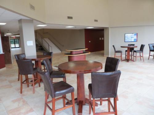A common area with stools and tall, circular tables