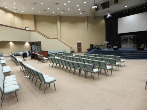 The school auditorium with chairs lined up in front of the stage