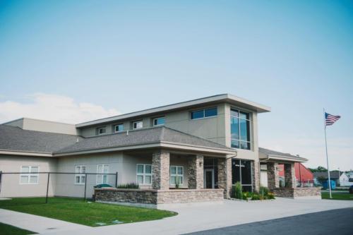 An angled view of the school entrance and flagpole 