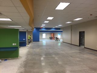 An open space under construction with construction workers in the background