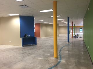An open space under construction with colorful walls and pillars