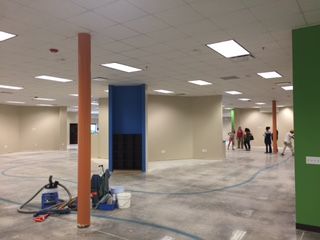 An open space under construction with some future students in the background