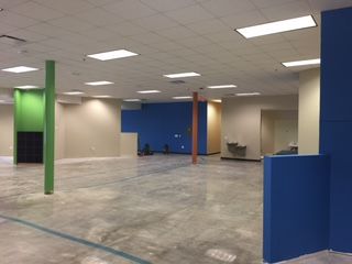 An open space under construction with colorful walls and pillars